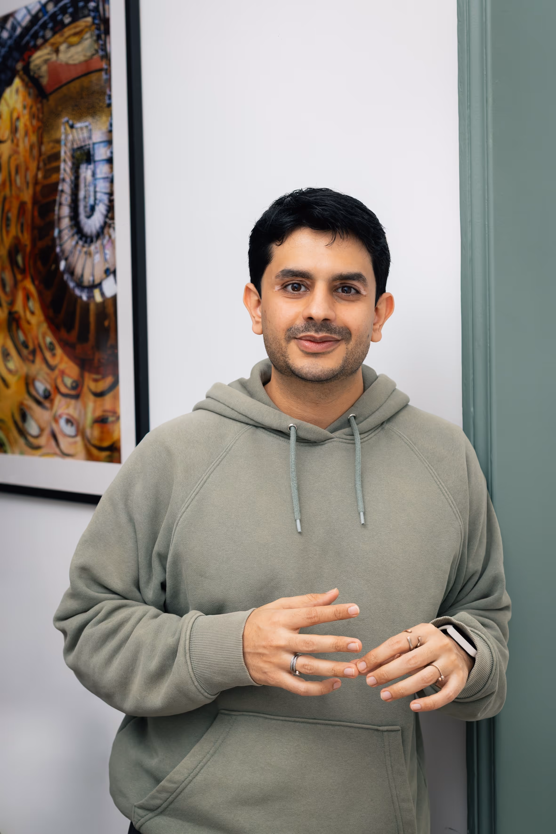 A close-up portrait of a man sitting and smiling.