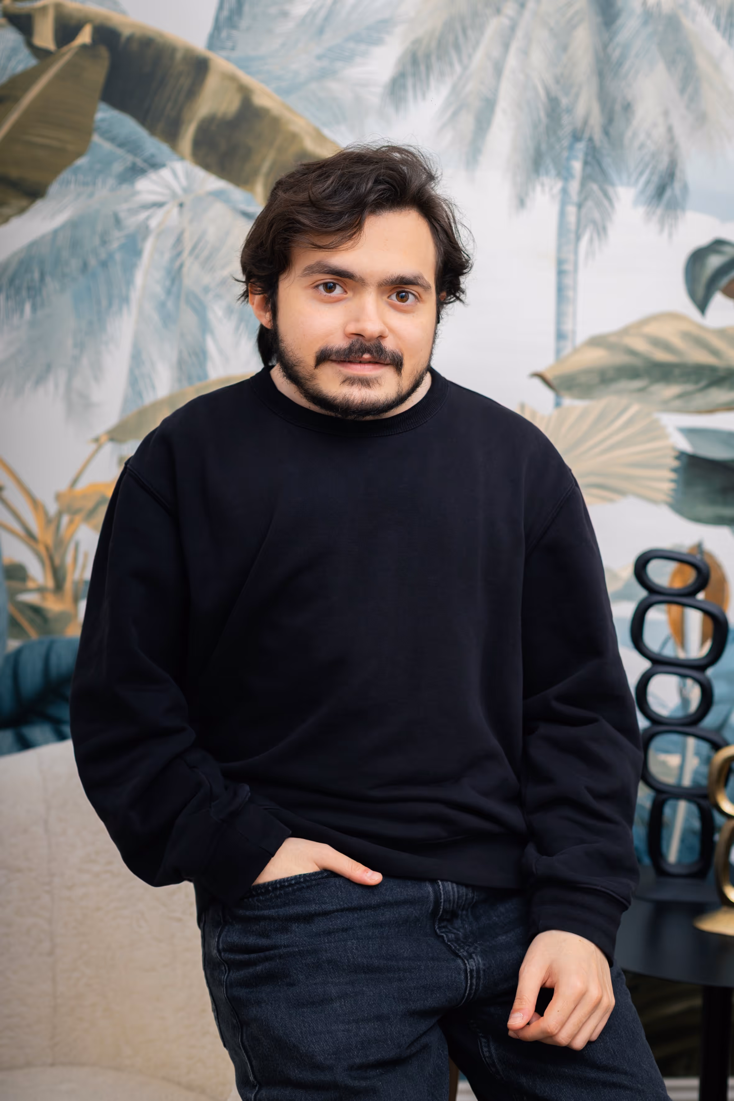 A portrait of a man sitting and smiling.