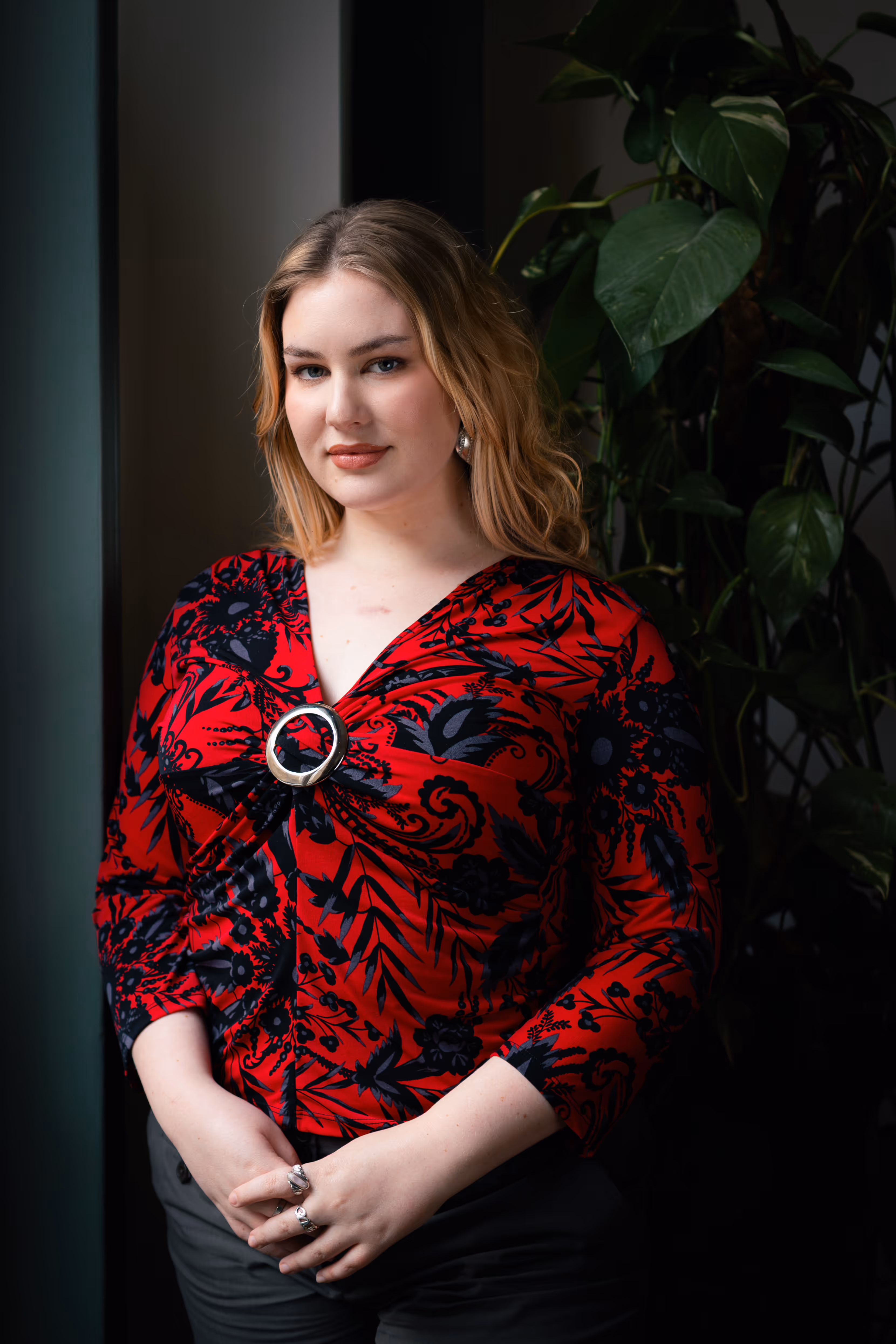 A portrait of a woman standing and smiling.