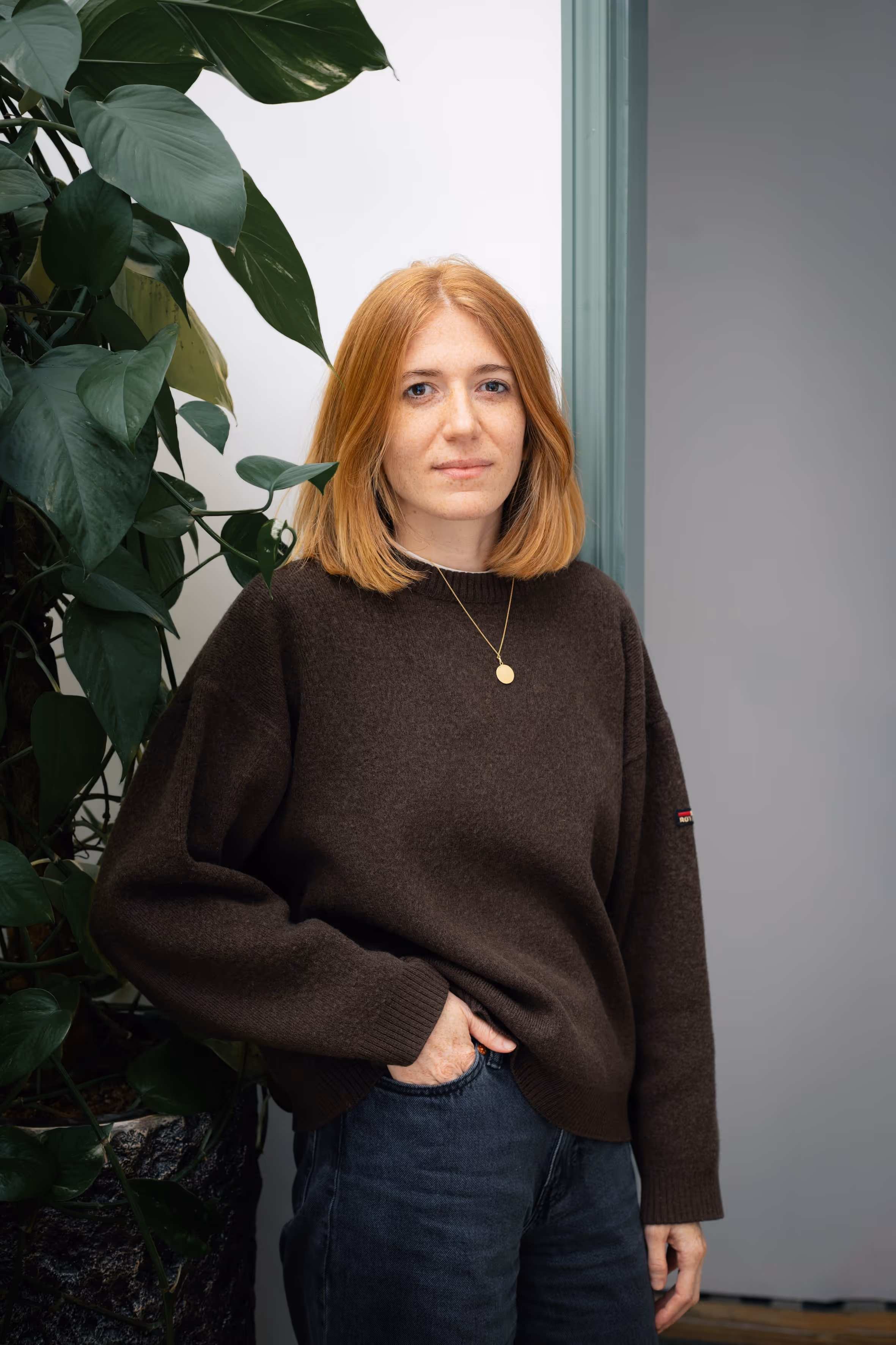A close-up portrait of a woman with blonde hair smiling.