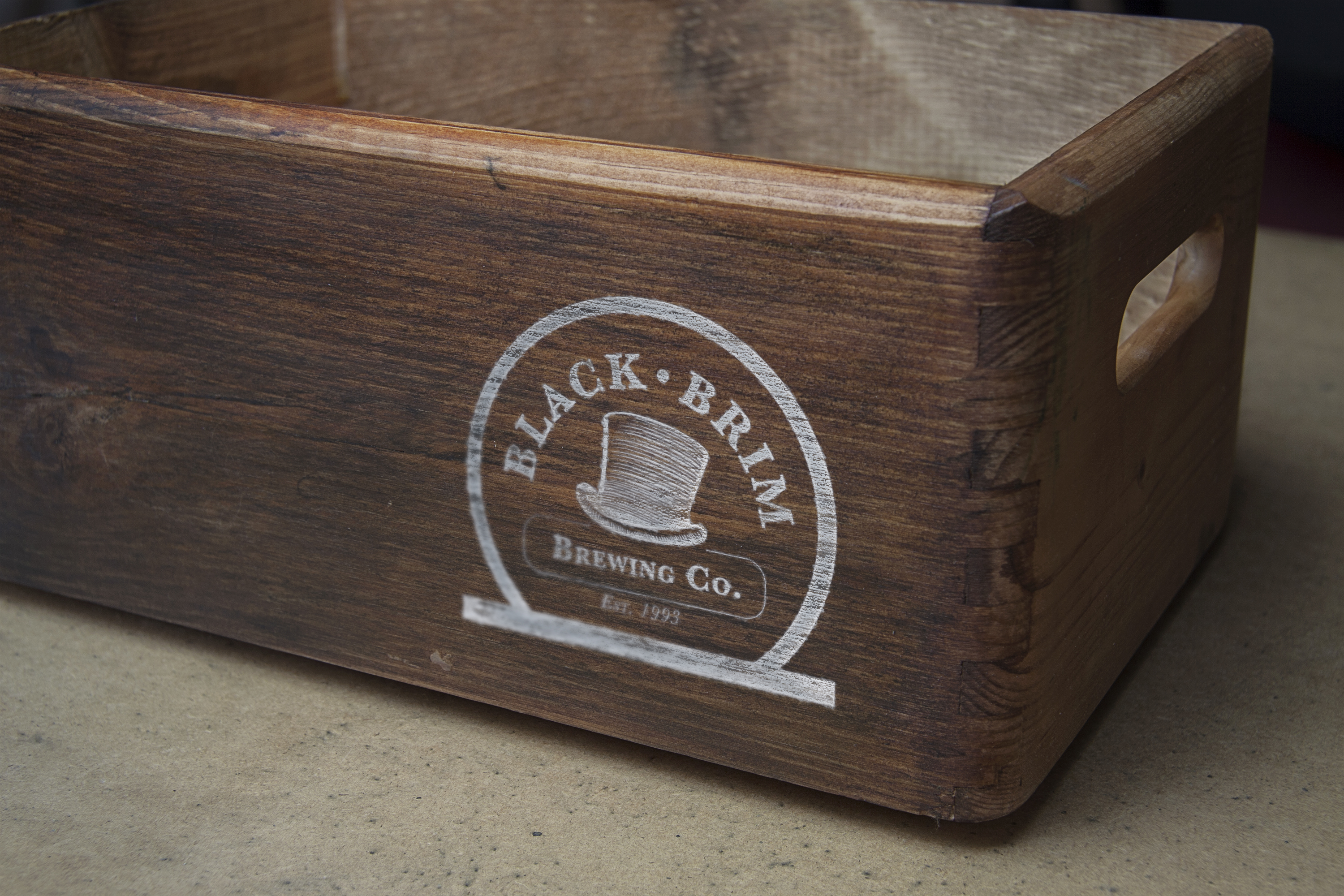 A wooden box with the Black Brim Brewing Co logo.
