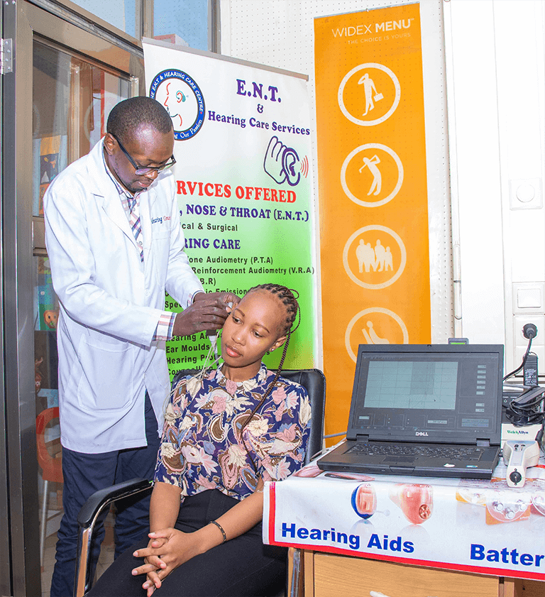 A n audiologist and lady illustrating the Oto Acoustic Emission testing (OAE)
