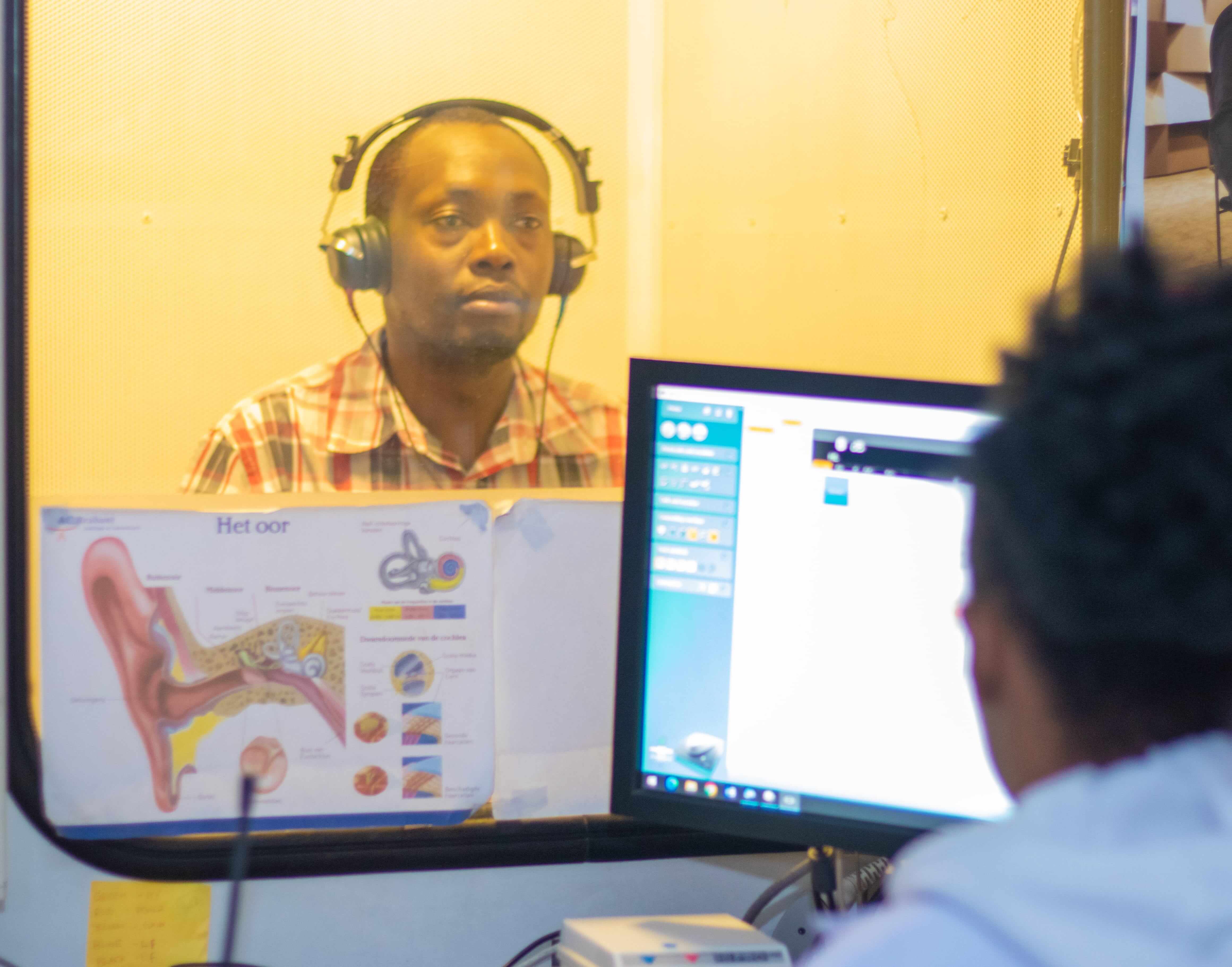 Audiologist performing hearing test