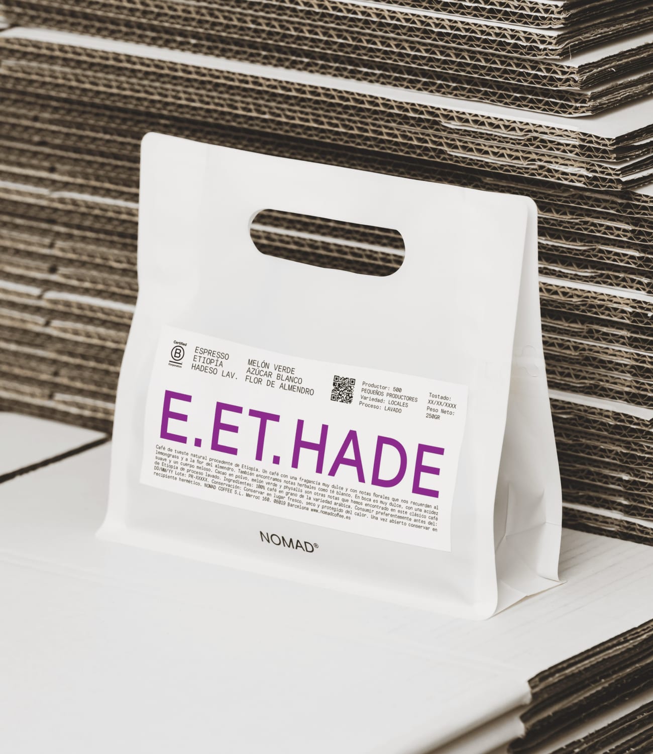 White Nomad paper carry bag with a purple E.ET.HADE label on a shelf