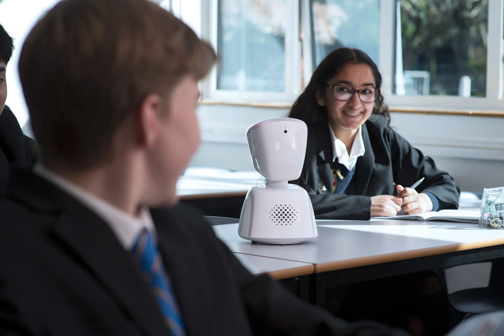 AV1 robot on a desk in a UK classroom representing an absent student