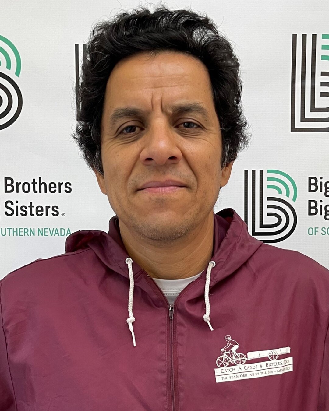 Edgar Batres Alvarado, Donation Center Driver, wearing a maroon jacket 