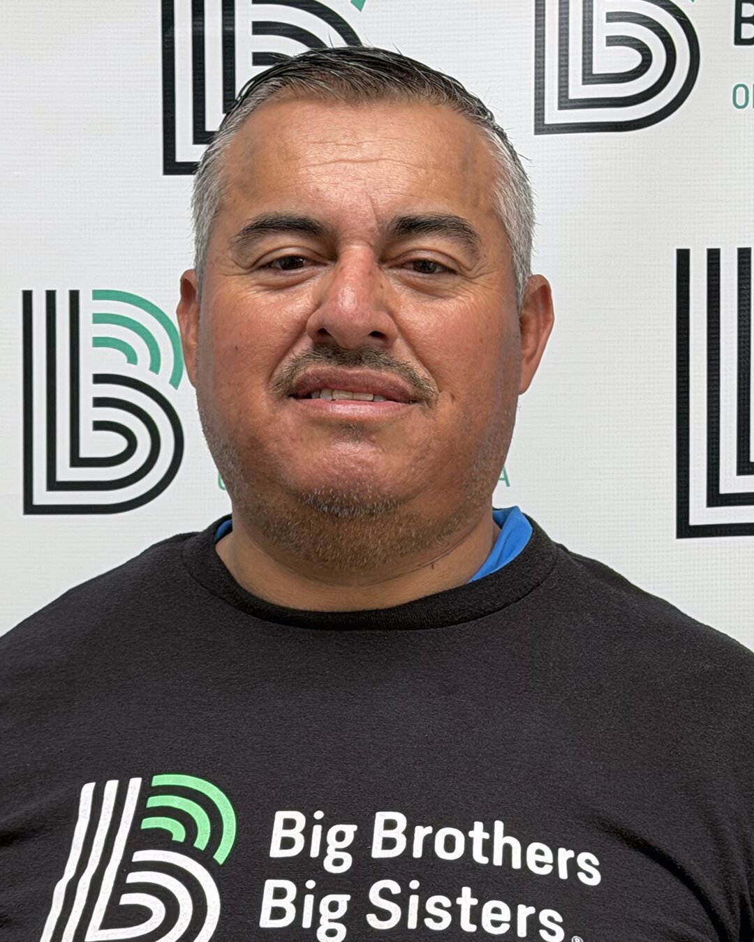Gerardo Hernandez, Part-Time Donation Center Driver, in a Big Brothers Big Sisters shirt