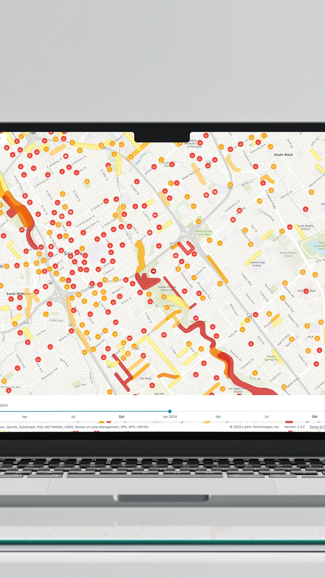 Laptop screen displaying a detailed map with colorful markers and paths representing data points around San Jose, California.