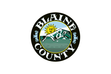 Seal of Blaine County featuring a sun, mountains, and a jumping fish with the text 'Blaine County'.