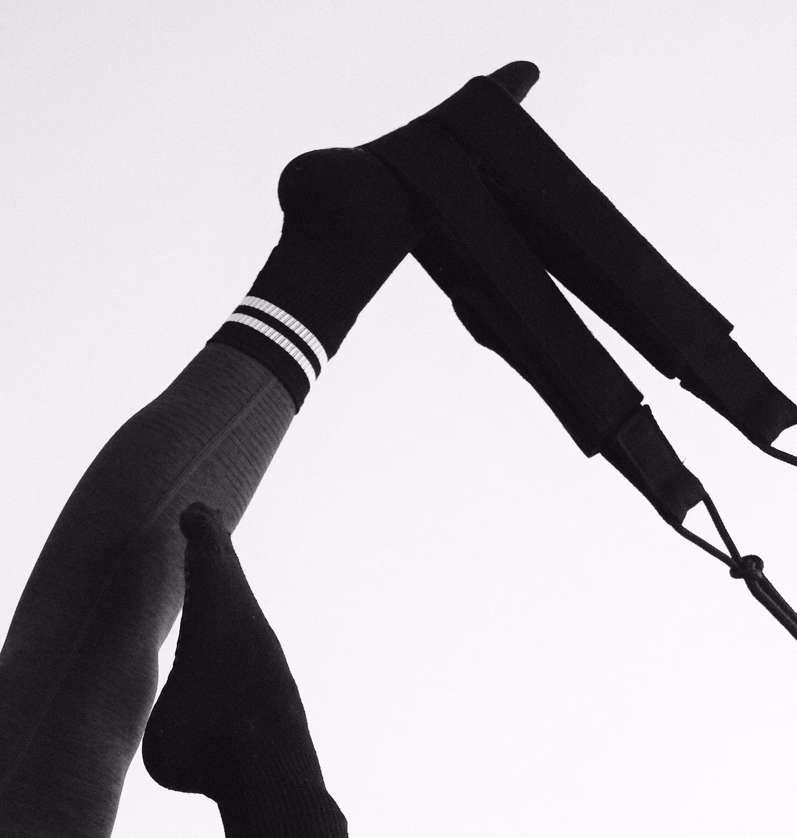 Abstract of a womans legs performing Pilates with a strap