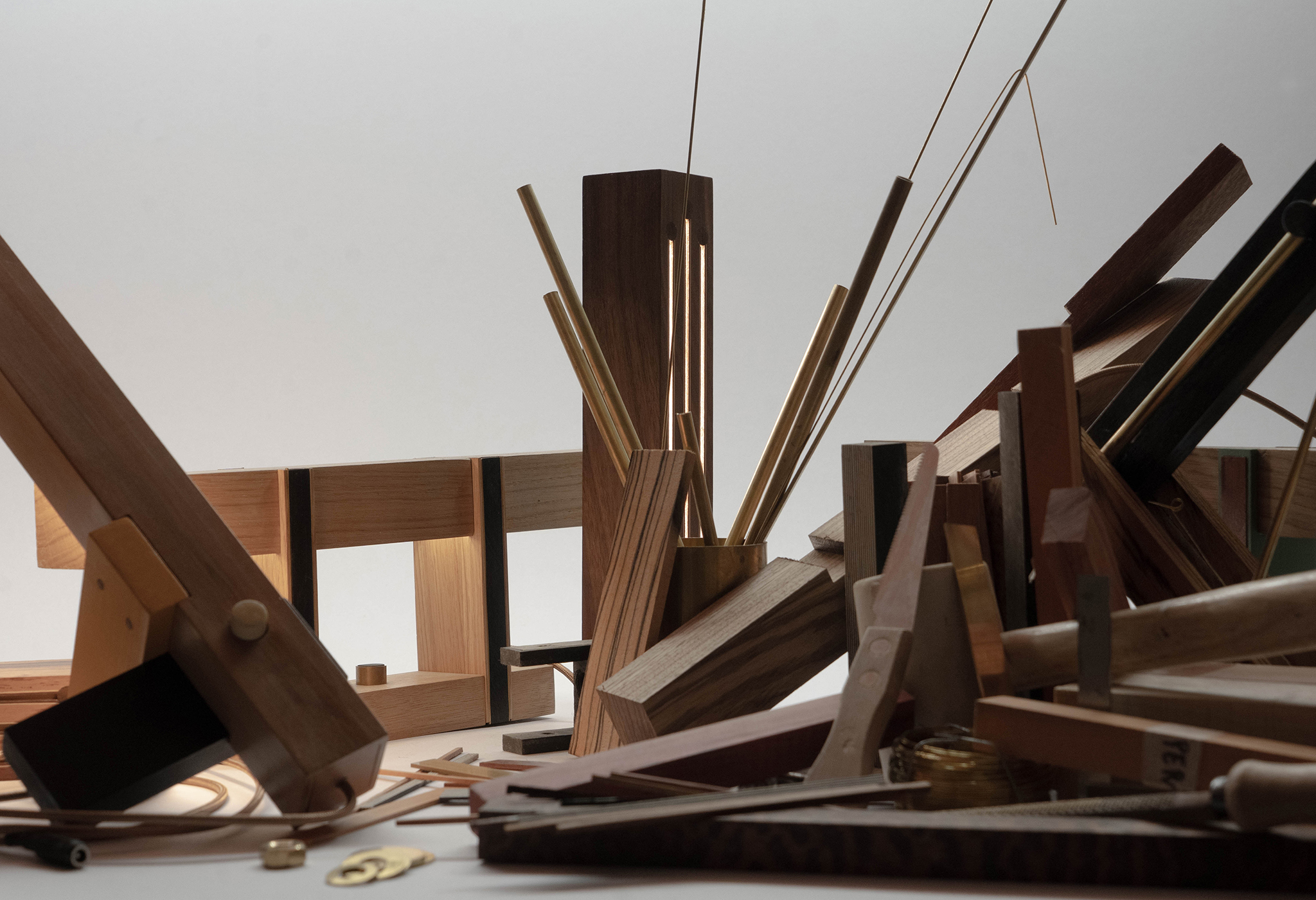 Chutes de bois et tiges de laiton assemblées sur l'établi de l'atelier Woowoo