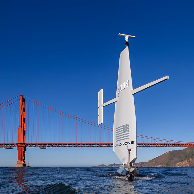 Saildrone unmanned surface vehicle sailing near the Golden Gate Bridge in San Francisco Bay on a clear day.