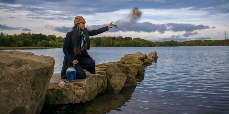 Woman scattering ashes at sea after cremation