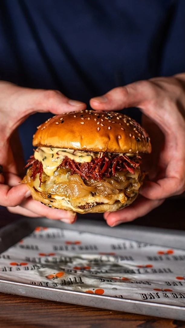 Join us this Thursday on everyone's favourite date National Burger Day! 🍔 

To celebrate, we are offering London's best burger for you and a friend at an incredible two-for-one price.

So grab your burger buddy and come try our Cowabunga. We start by smashing two of the finest beef patties, then load them with smoked Applewood cheese, slow-cooked beef brisket, rich béarnaise sauce, and sweet ale onions. This beautiful creation is perfectly sandwiched between a fresh brioche bun for your enjoyment.

Don’t wait—mark your calendars and join us on August 21st for the entire day as we indulge in one of life's greatest pleasures with this fantastic two-for-one offer!