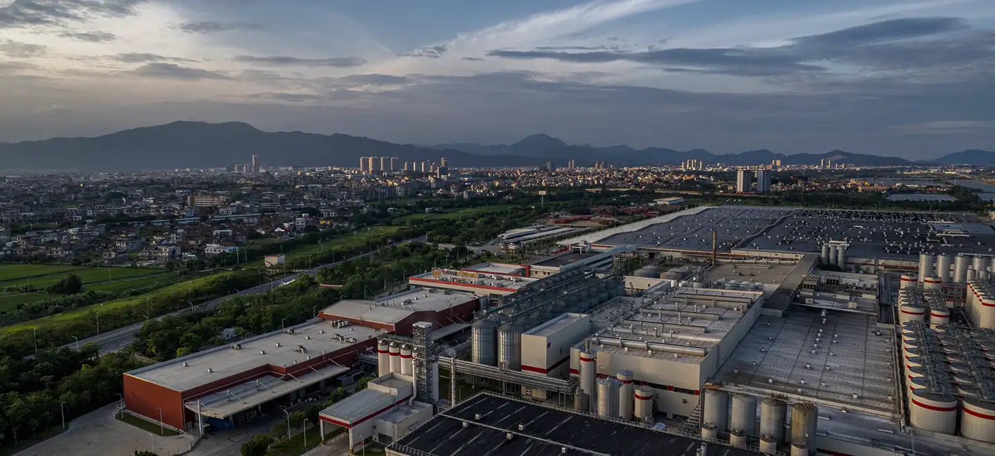 Skyline over a city with manufacturing buildings in front