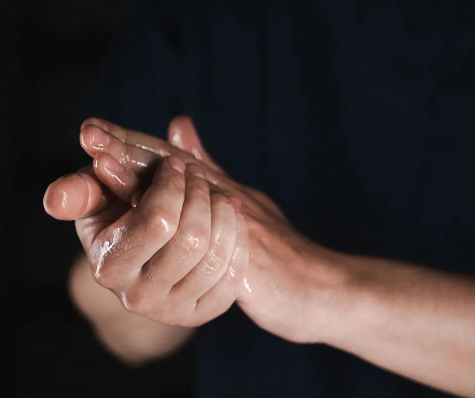 Hands prepared for a massage therapy session at ReyHealth
