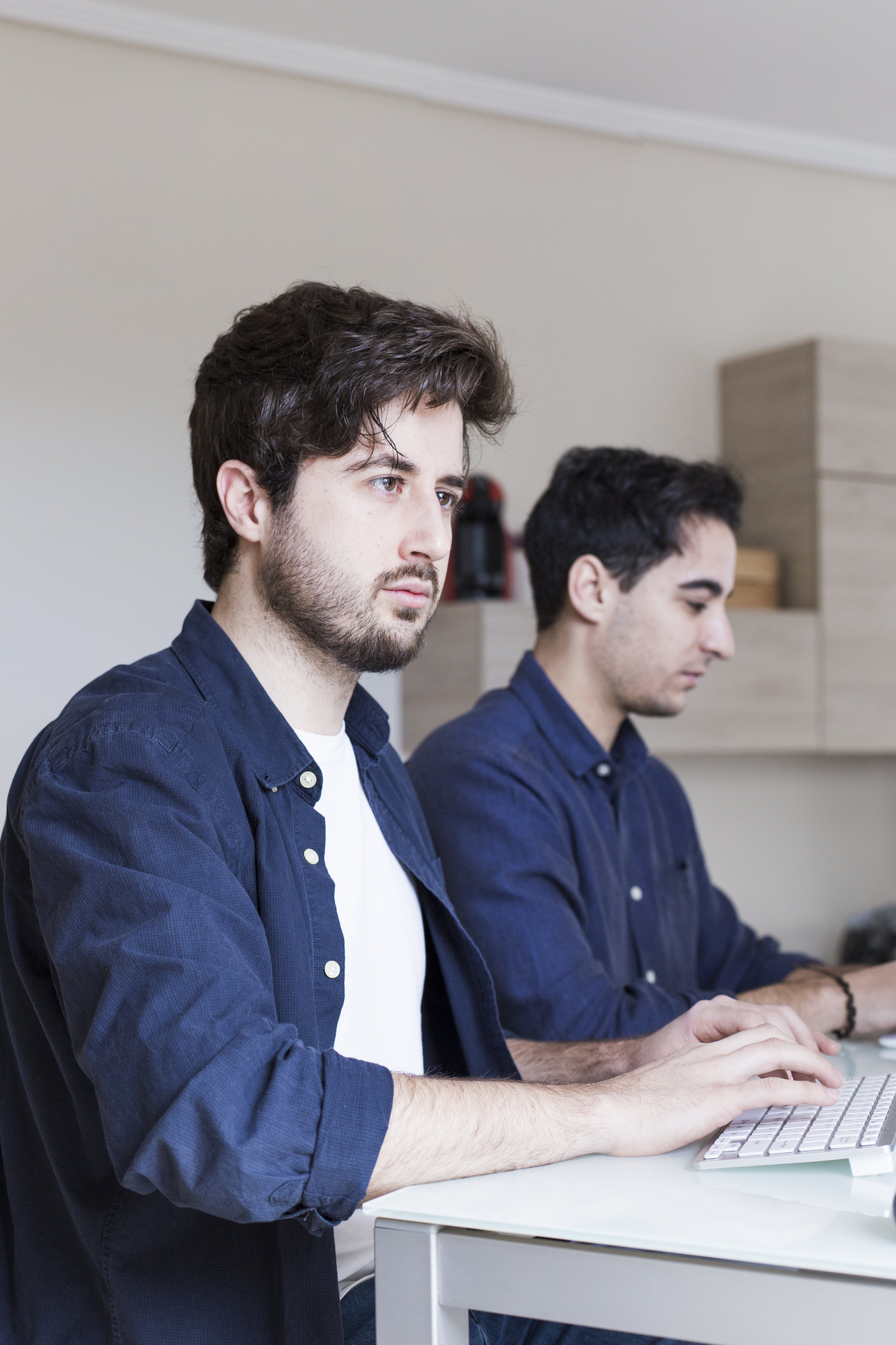 Two men typing