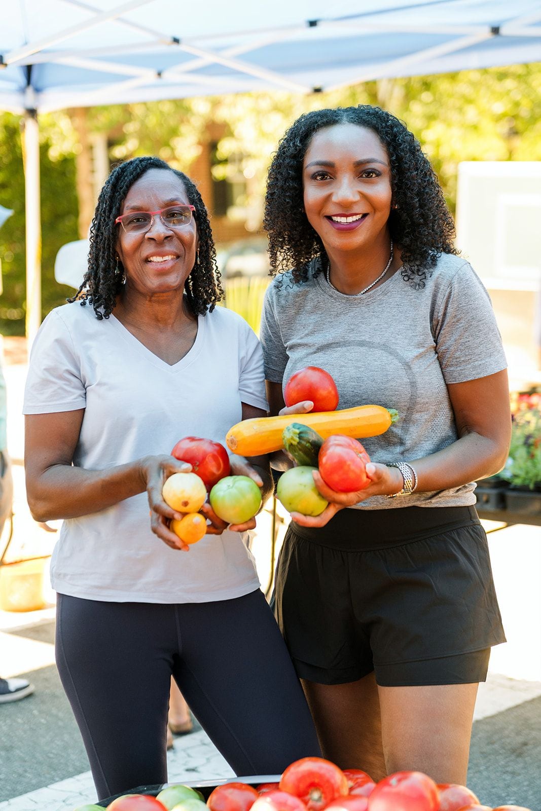 The Well Unscripted team selecting fresh produce at a local farmers market
