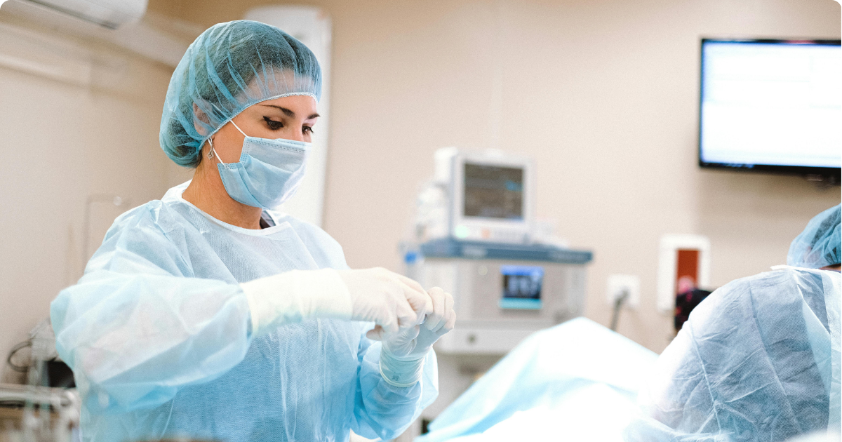 a female doctor in an operating room preparing to begin surgery