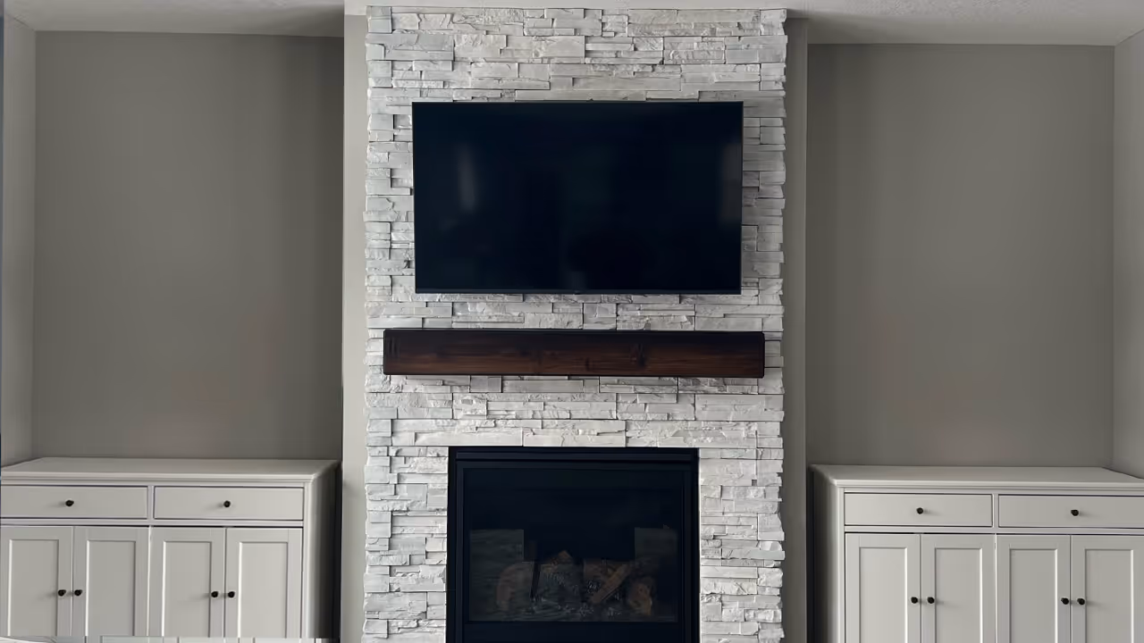 Flawless 55" Samsung TV installation above a stone fireplace in an Edina, MN home.