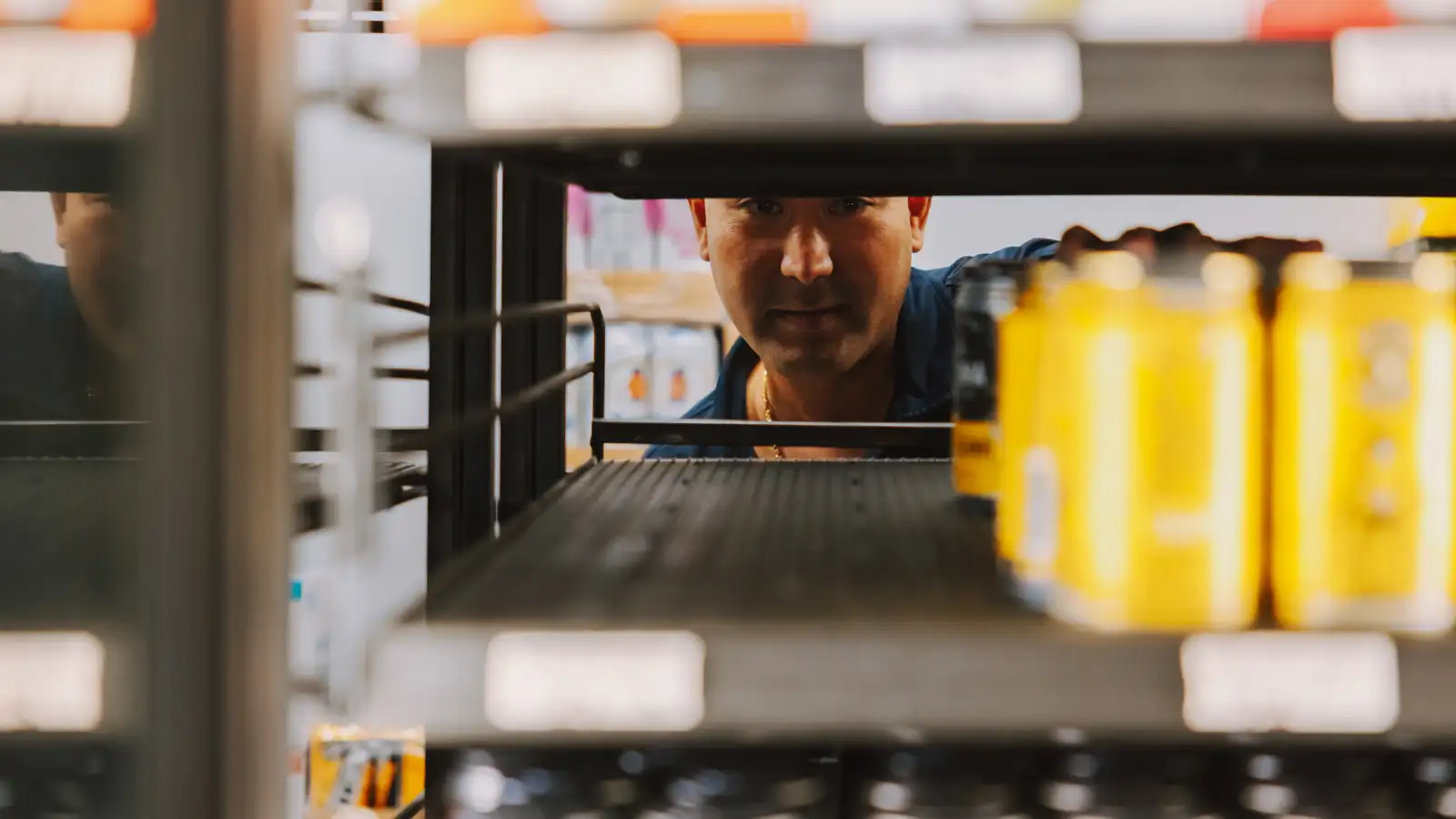 Alex peering through the shelves