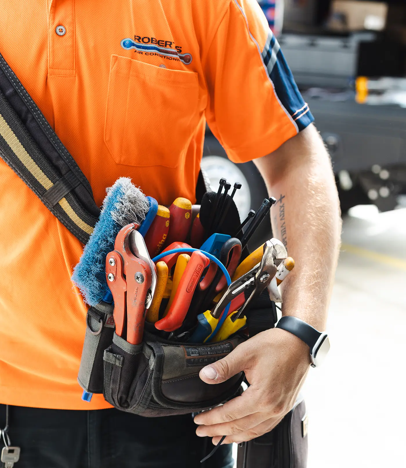 man looking in a car at trade tools