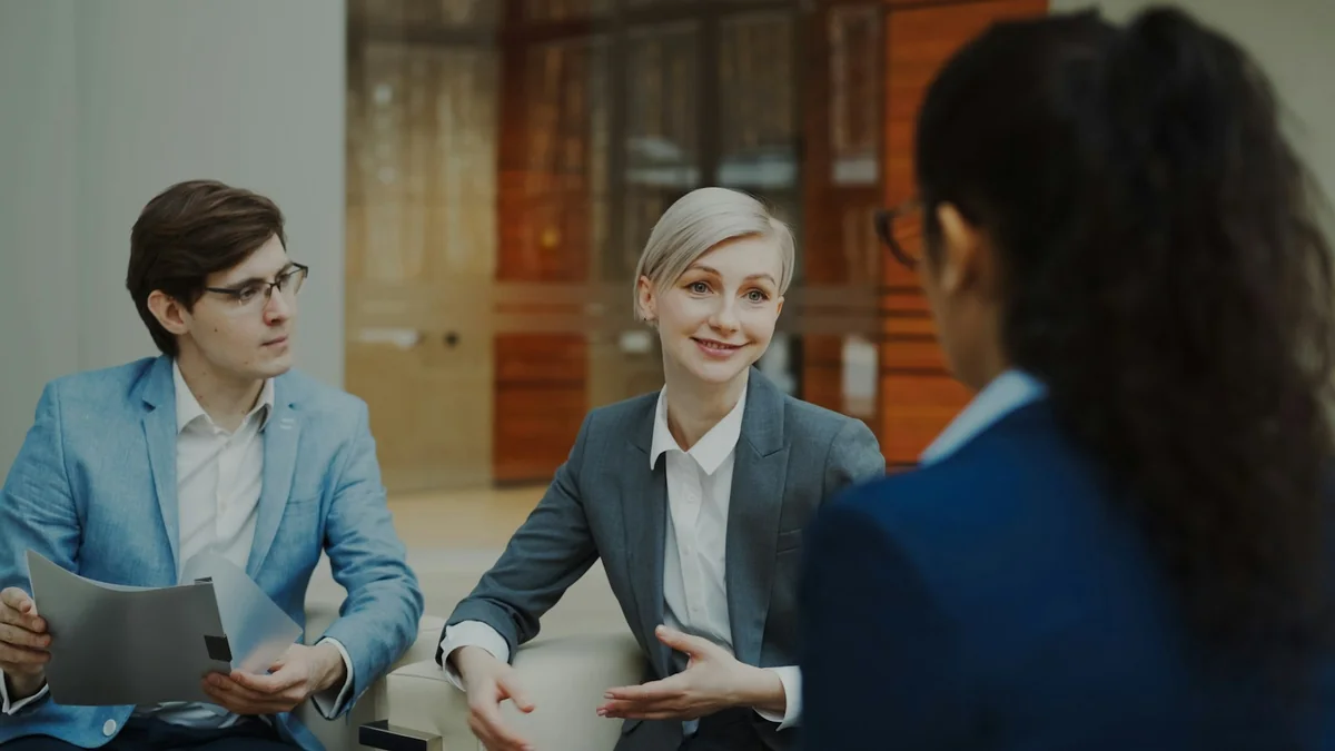 Illustrative photo of people reviewing documents together in a professional setting