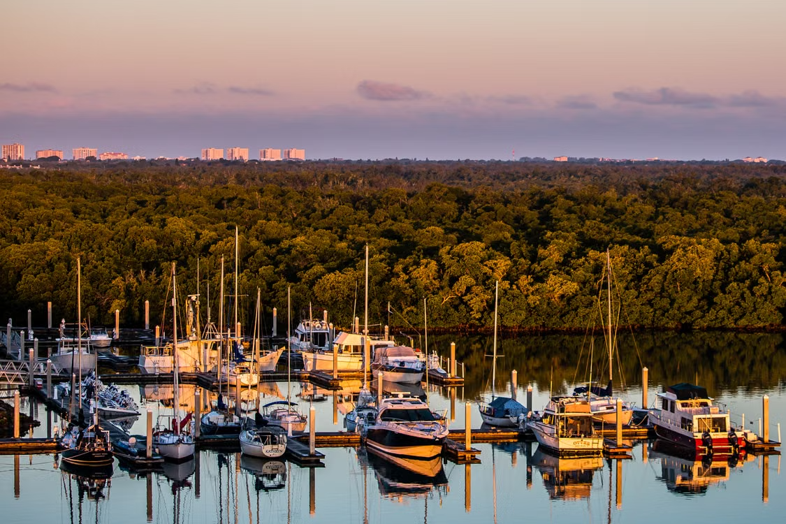Boats docked at a Florida marina, illustrating why boat owners ask do i need umbrella insurance in florida