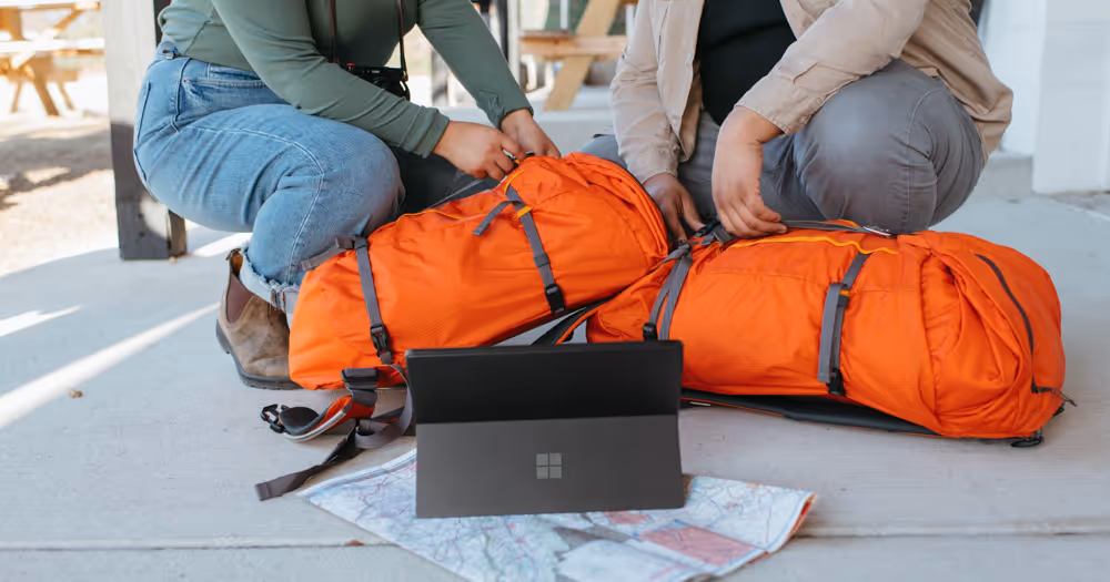 Two travellers using ai travel planners to plan their trip.
