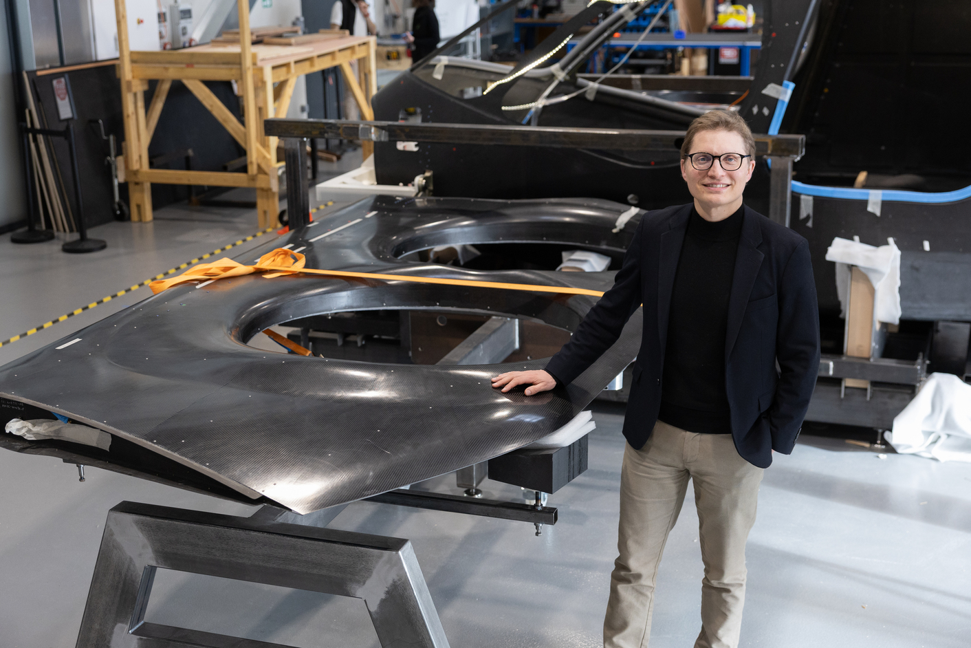 Ascendance team member standing beside a carbon lift module of the Atea aircraft