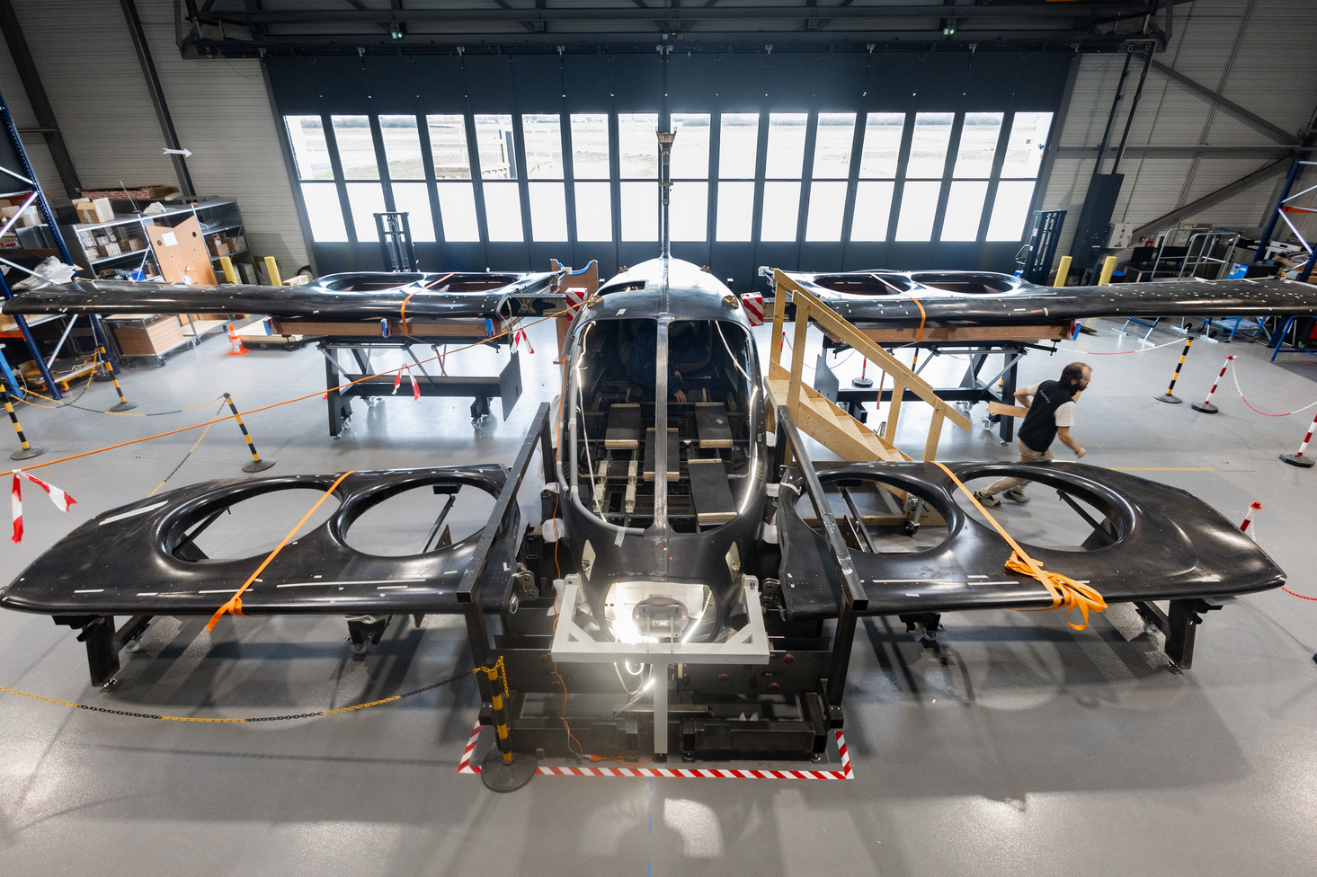 Front view of the Atea prototype with its wings and lift modules in the assembly hangar