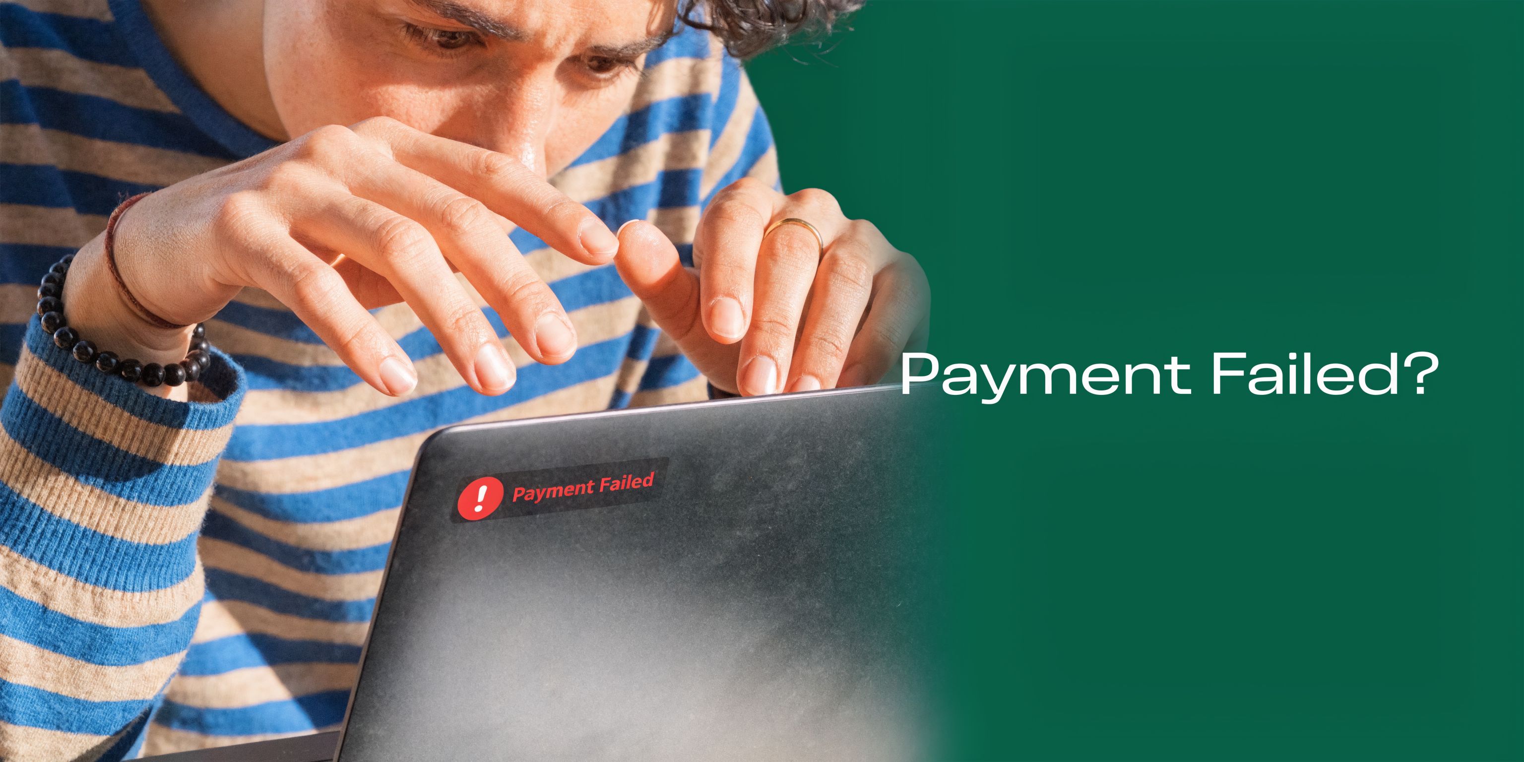 A person looking frustrated at a laptop computer displaying a red payment failed error message notification.