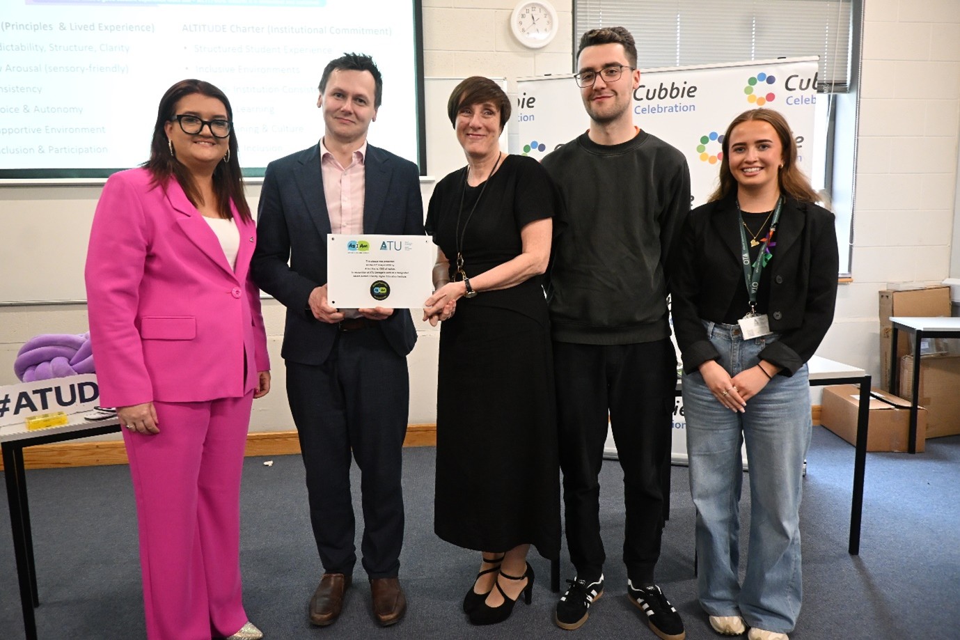 Five people at ATU holding an AsIAm Autism Friendly HEI Award plaque.