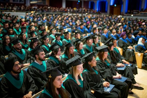 Bow Valley College graduates sitting at the Arts Commons auditorium.