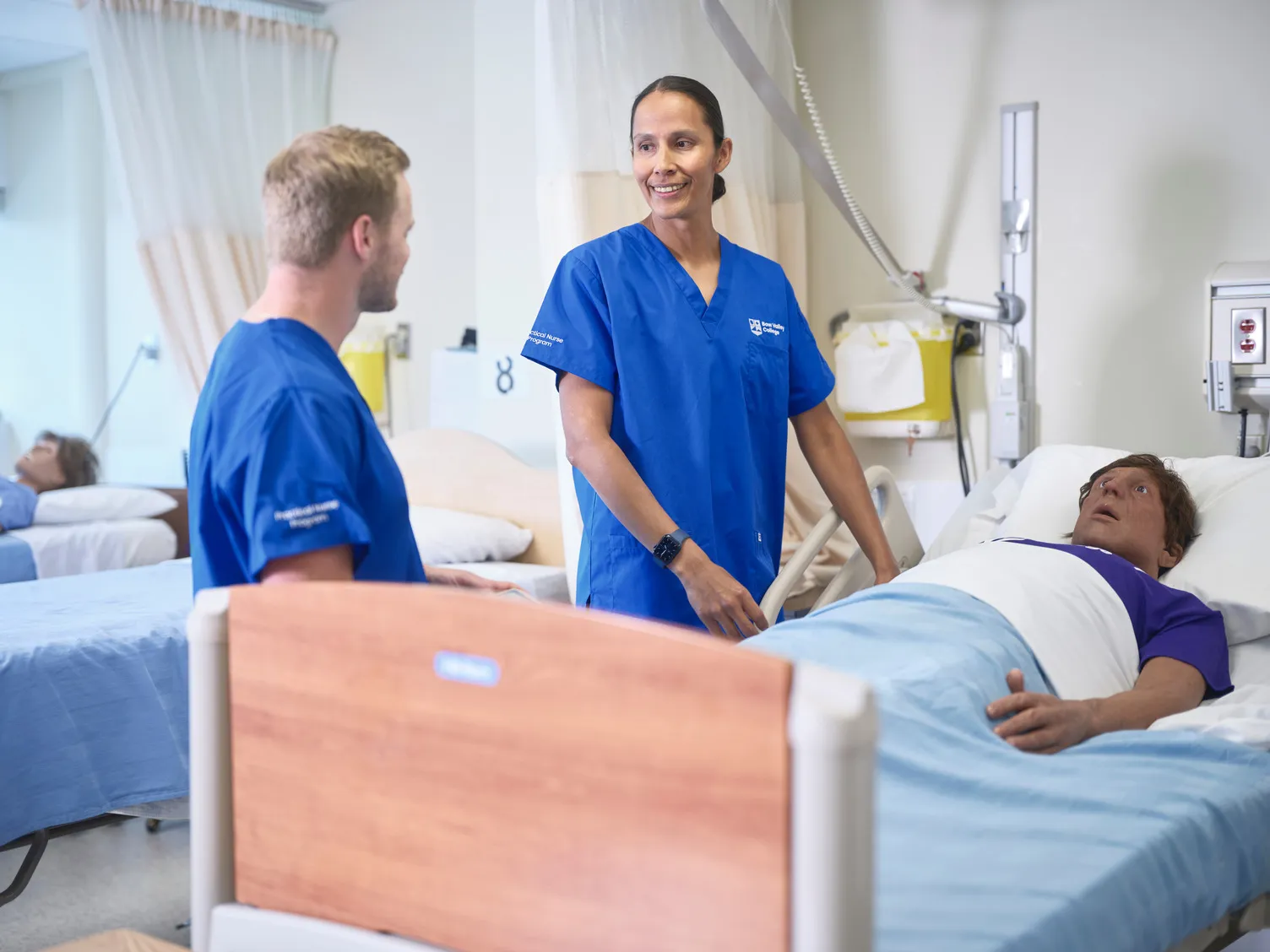Nursing students working with a dummy patient
