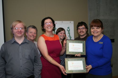 Project search team smiles and holds certificates