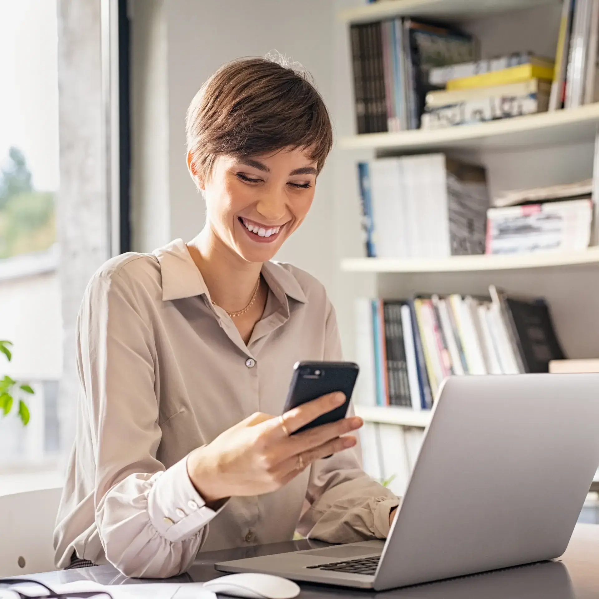 a woman sitting in front of a laptop computer