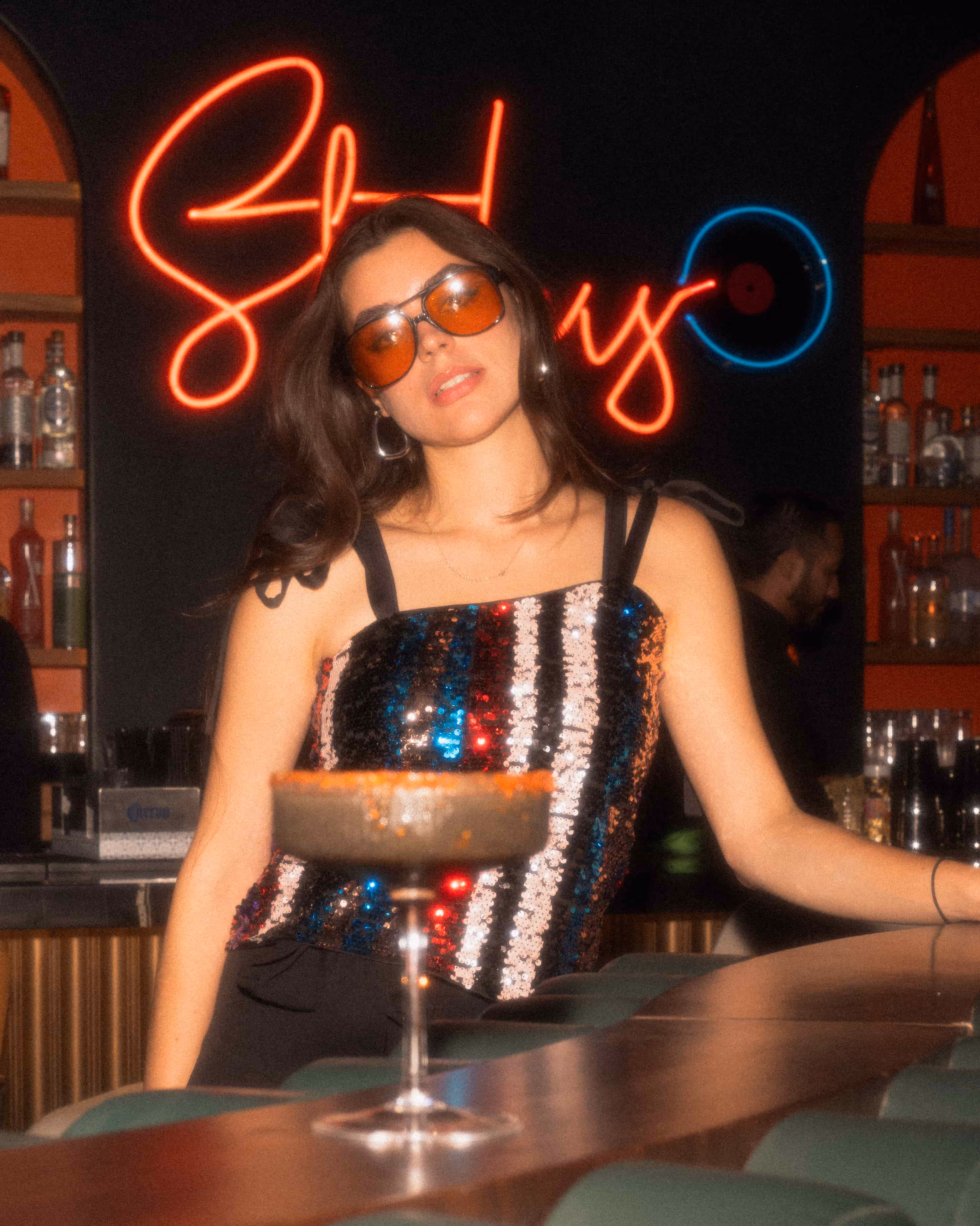 Stylish woman enjoying retro cocktails at Stylus Mixology San Antonio