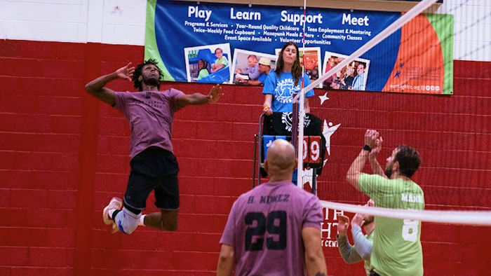 Players in philly vollyball team jersey's playing volleyball