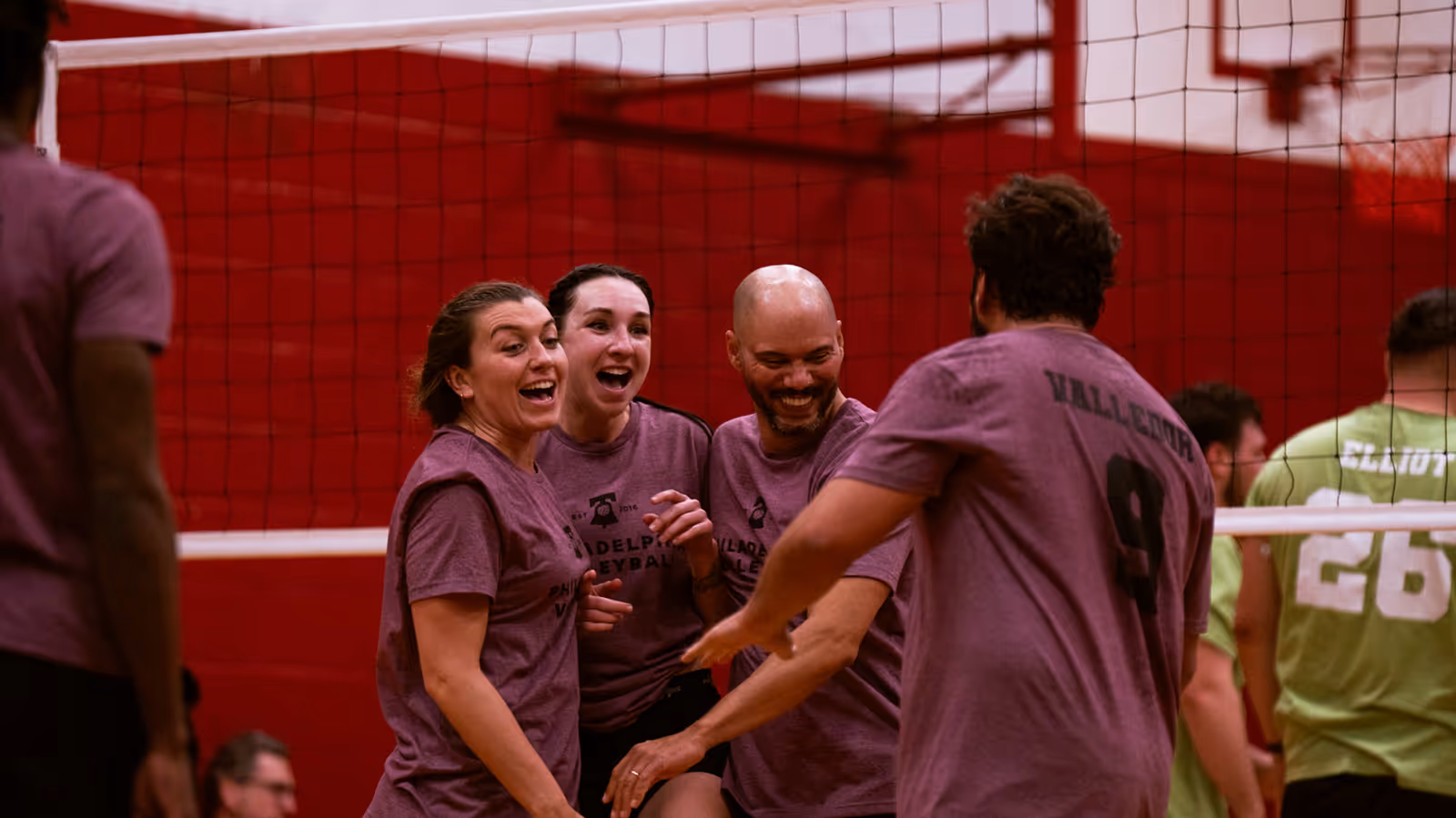 Volleyball league team celebrating after a point