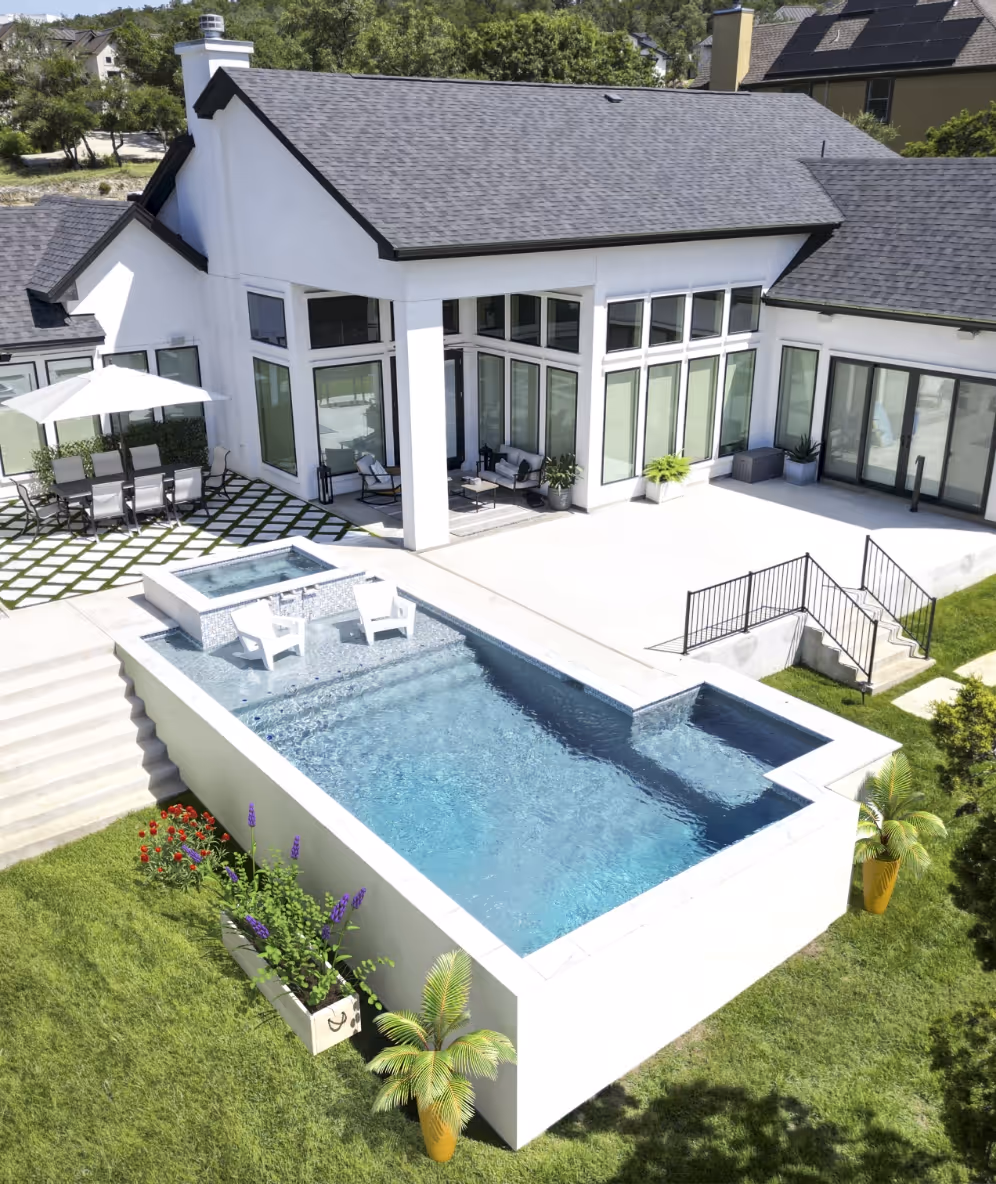 Elevated modern pool with outdoor seating and lush landscaping at a contemporary white home