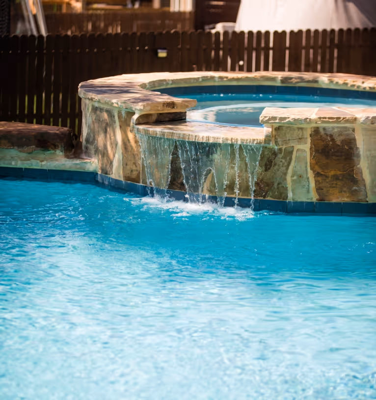 Pool builder in New Braunfels, Texas shows off new pool with a cascading stone waterfall