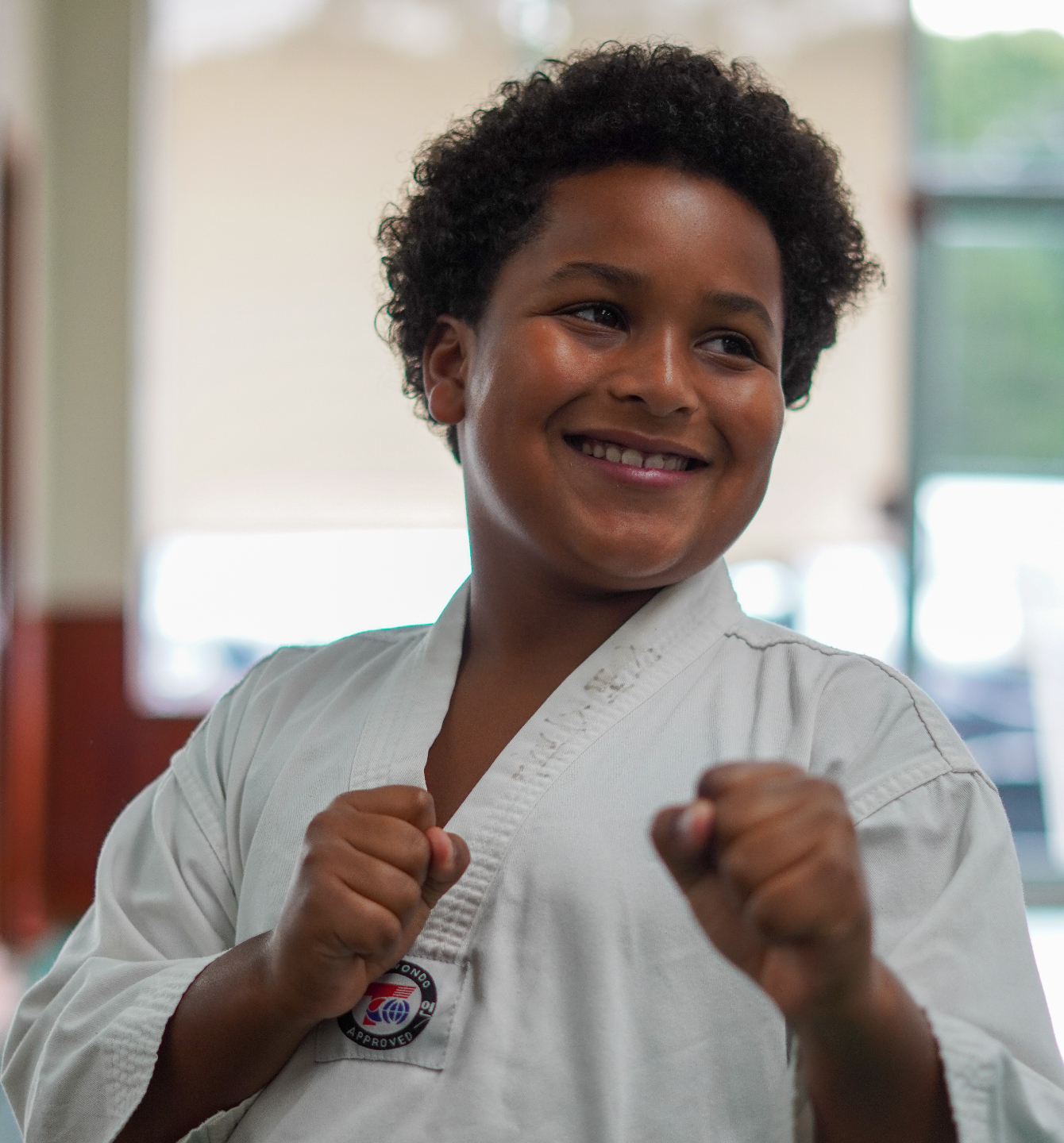 A martial arts instructor correcting a girls technique