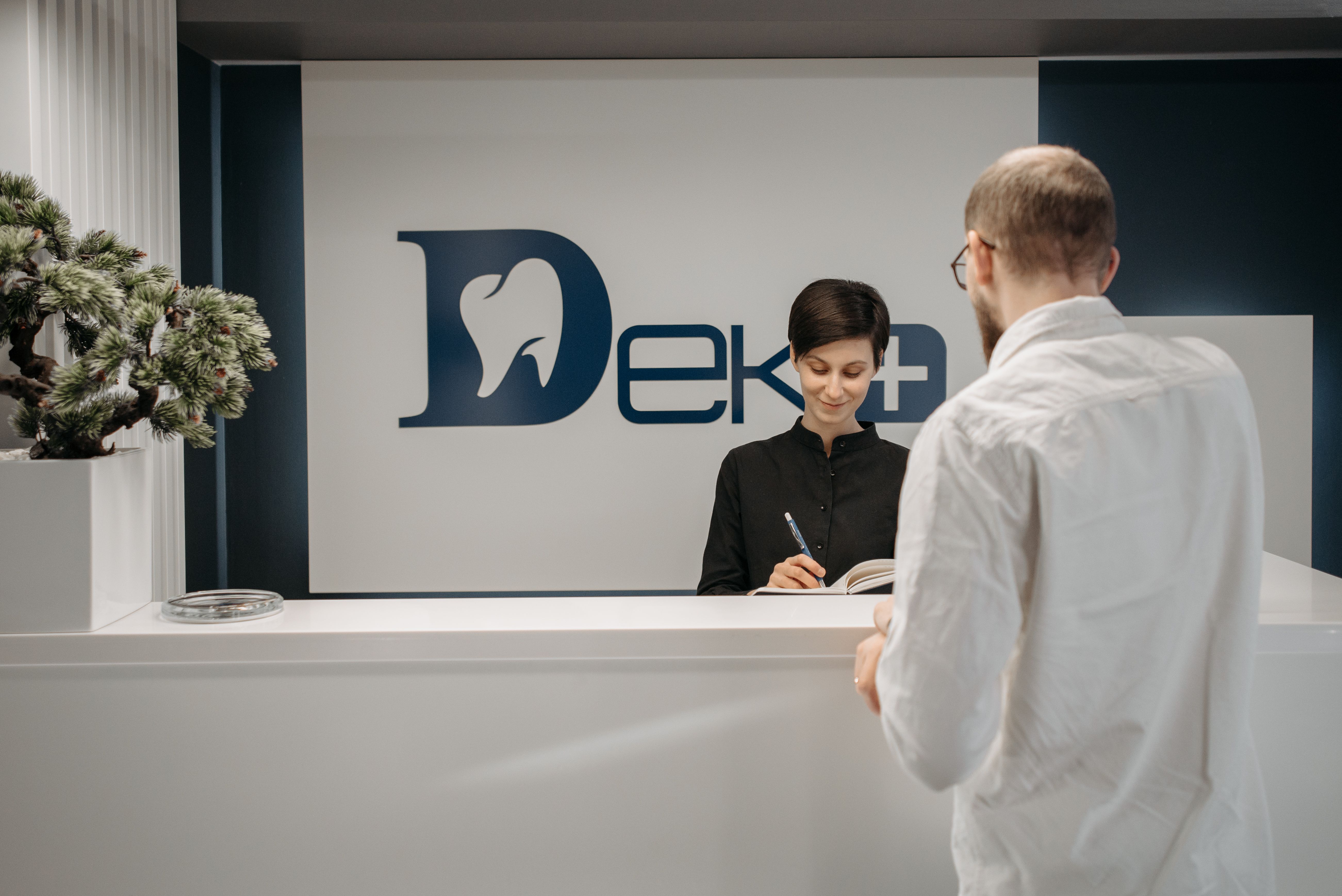 Patient reviewing dental insurance coverage with front desk in Minnetonka MN dental office
