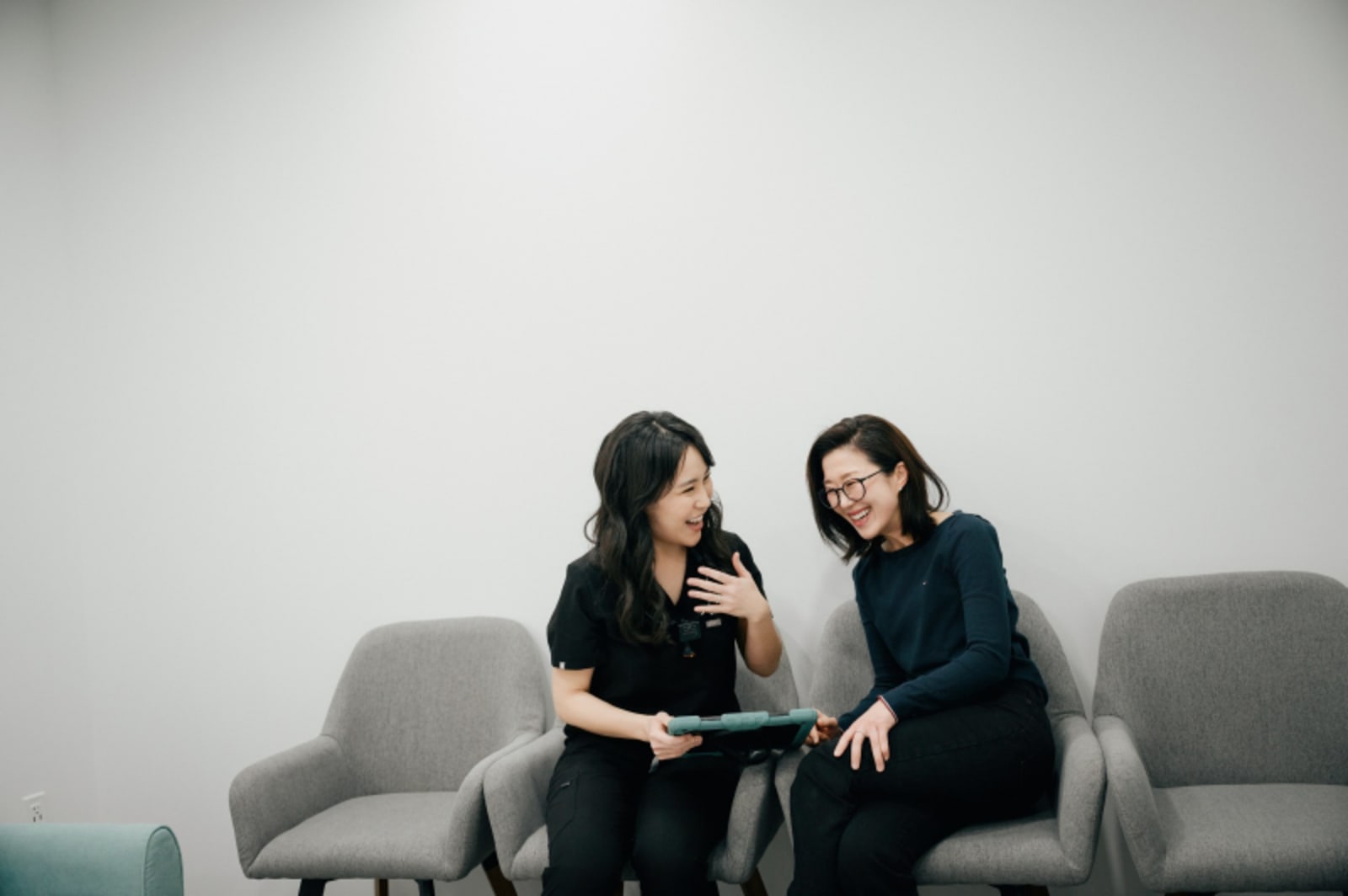 Two women having a consultation conversation while seated together