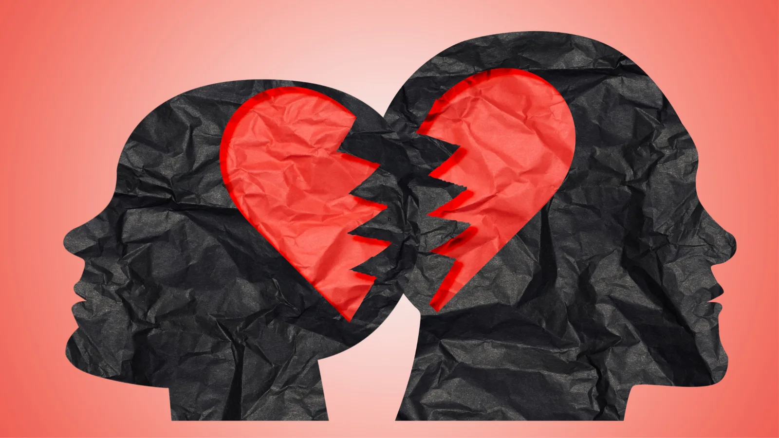 Two face silhouettes with a torn heart between them.