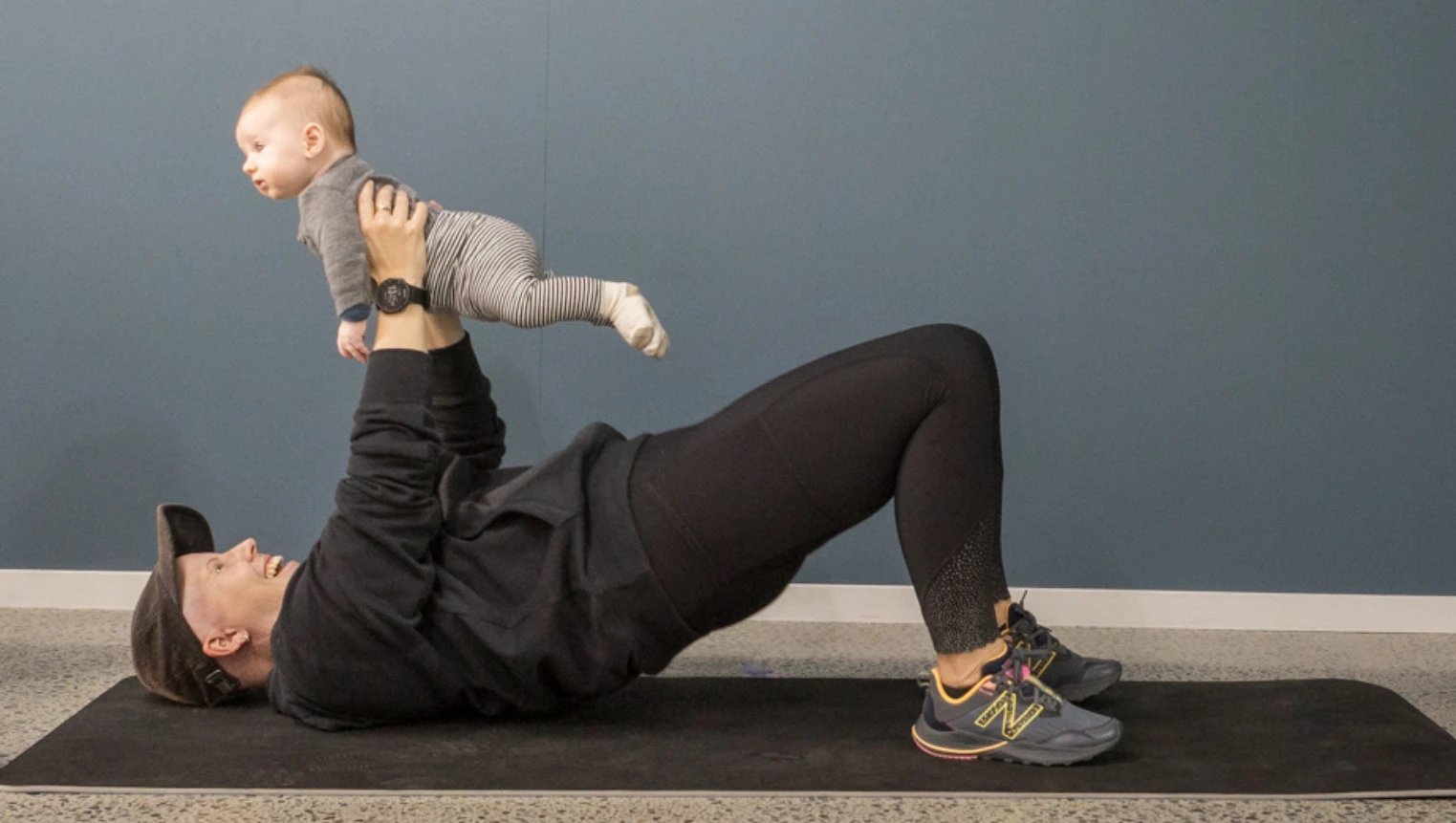 A group of adults on matts involved in a pilates class