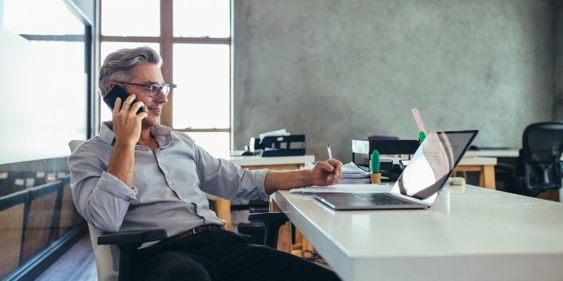 Broker sitting at desk calling Bizcap, getting his questions answered 