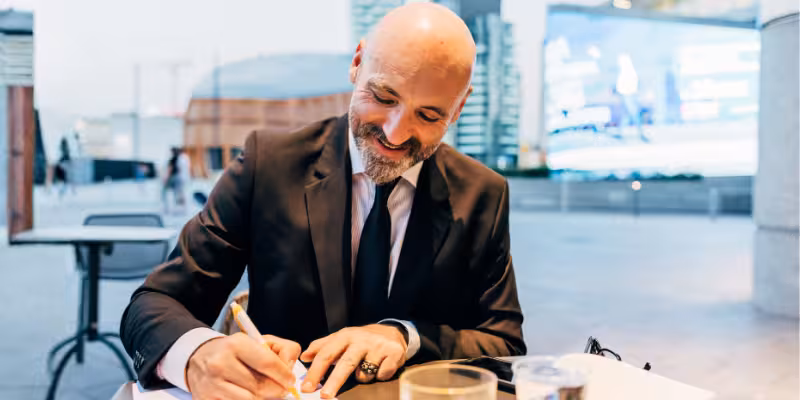 Professional broker signing their clients business loan approval