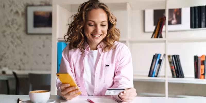A female small business owner reviewing documents, with a credit card